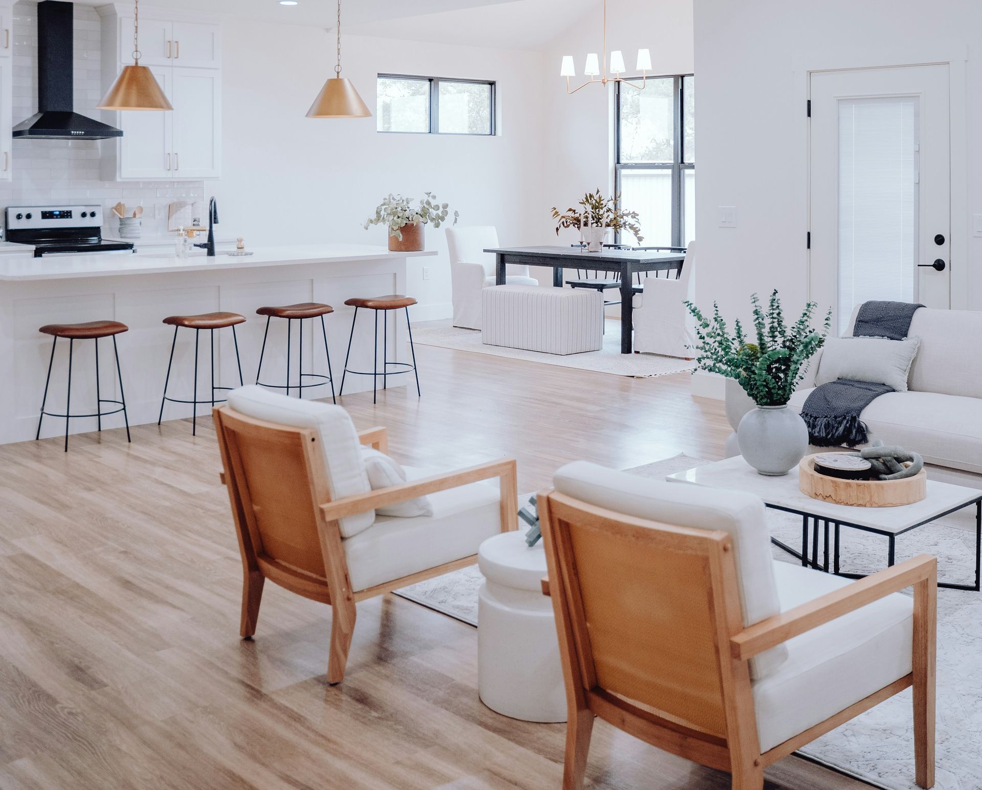 a living room filled with furniture and a kitchen